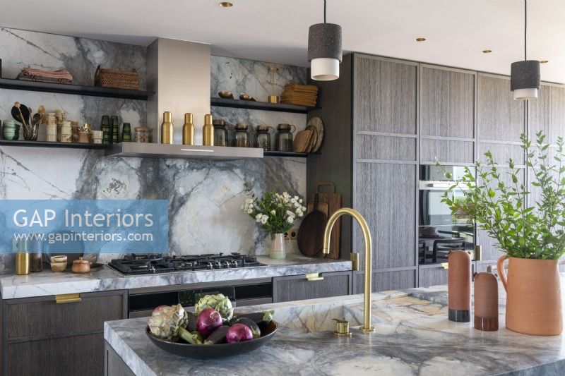 Elegant contemporary kitchen with marble worktop and splashback