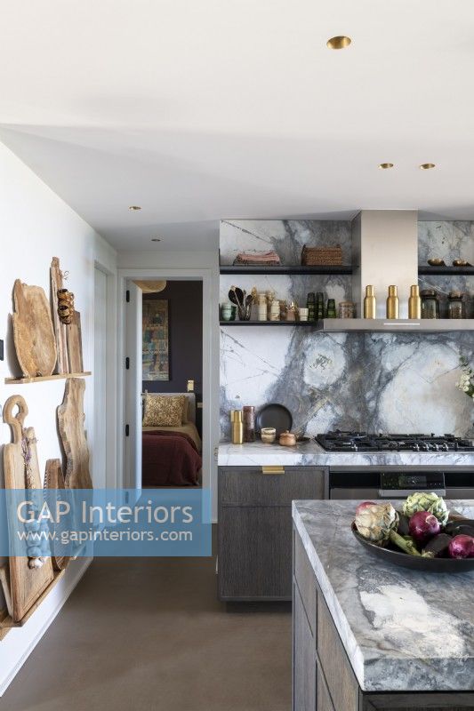 Marble worktops and splashbacks in contemporary kitchen