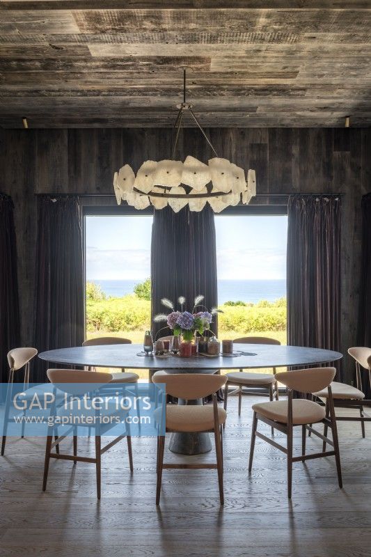 Contemporary dining area with sea views through large windows
