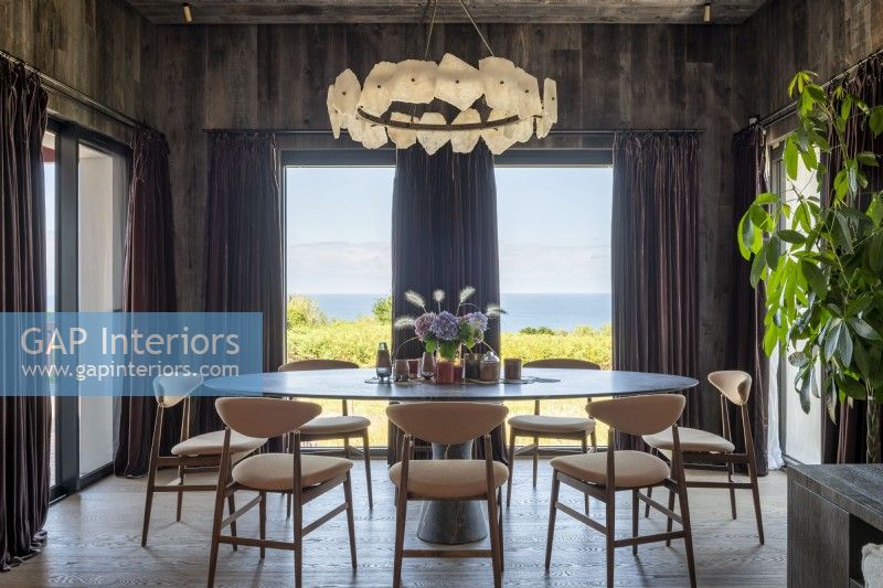 Elegant dining room with coastal views through large windows