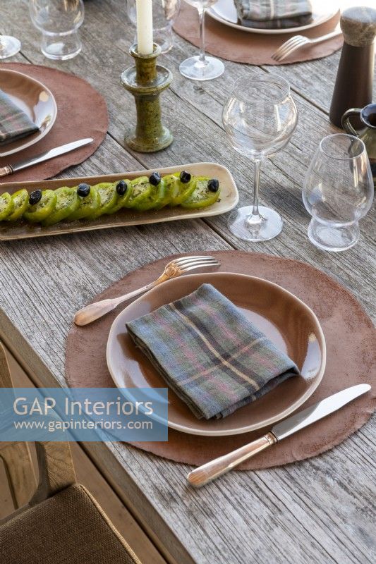 Detail of place setting on outdoor dining table in summer