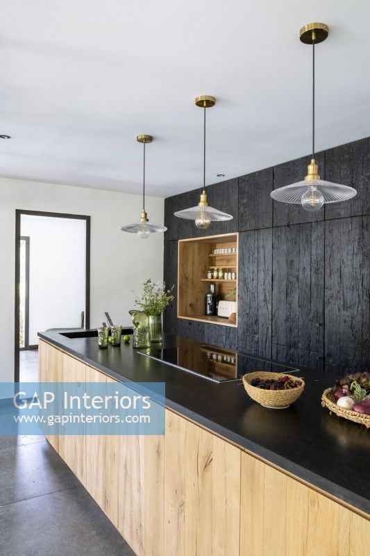 Modern kitchen with black cabinets and worktop