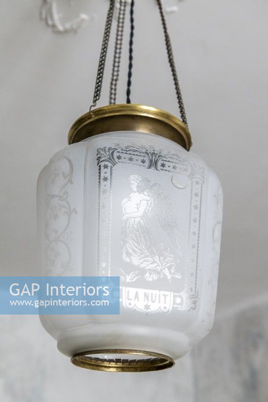 Detail of decorative glass and brass pendant light