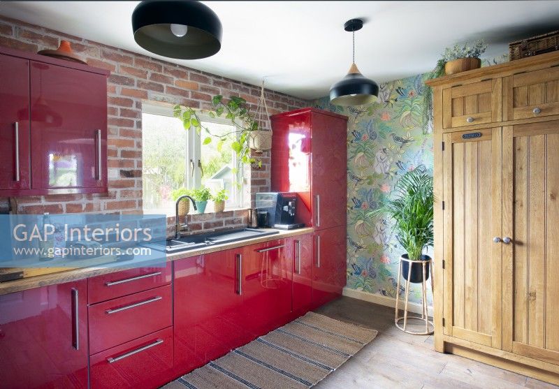 Red cabinets in colourful kitchen
