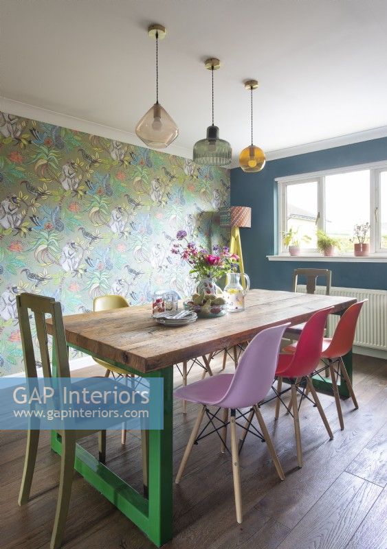 Colourful dining room with wallpapered feature wall 