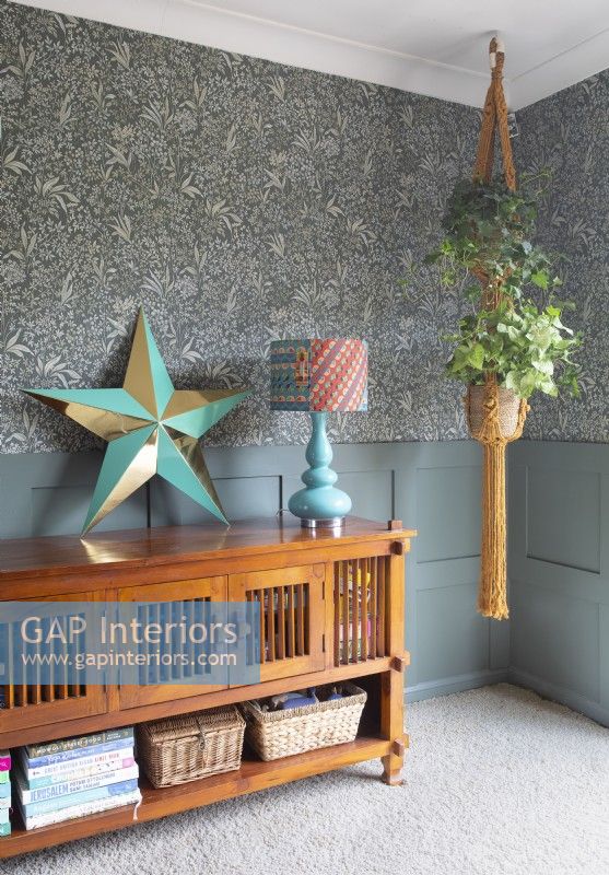 Wooden sideboard with decorative star ornament and houseplant
