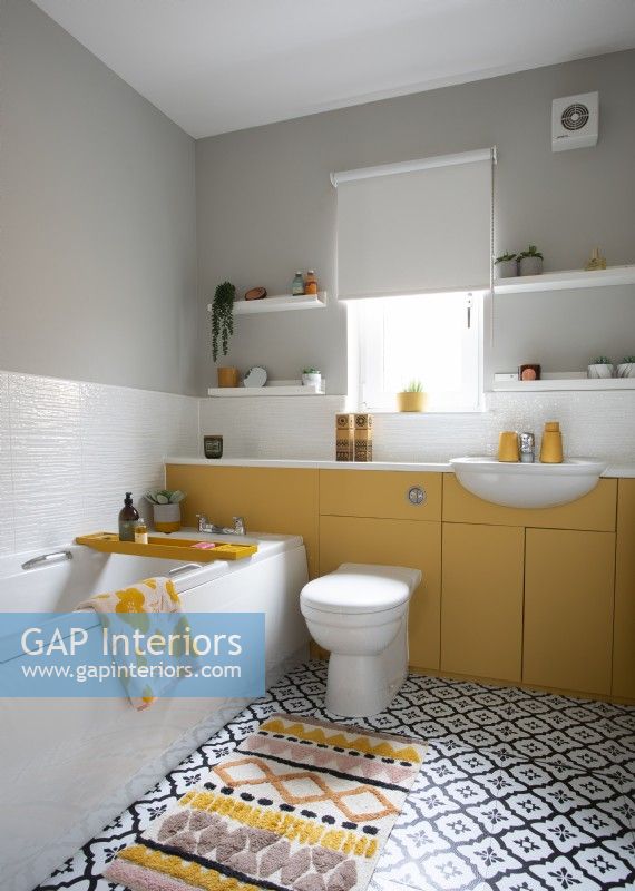 Yellow and white bathroom with patterned monochrome flooring