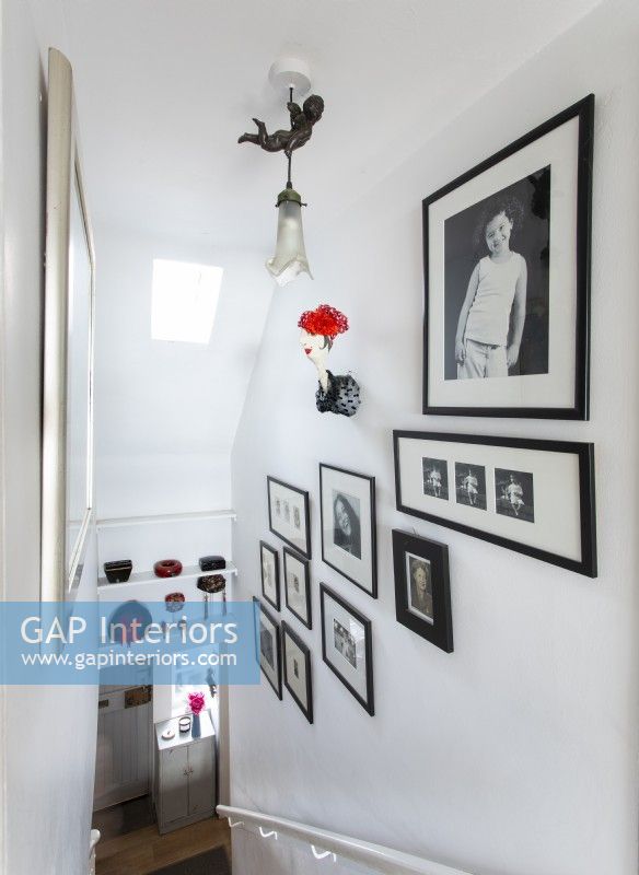 Black and white framed photographs on staircase wall