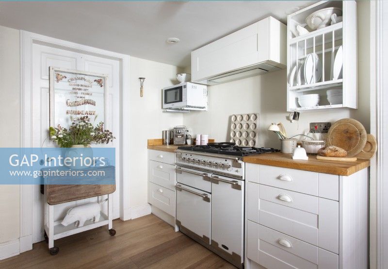 White and wooden country kitchen with range cooker
