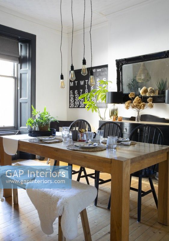 Chunky wooden table in black and white dining room