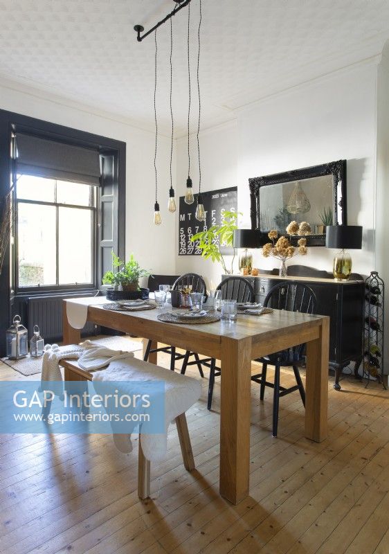 Chunky wooden table in black and white dining room