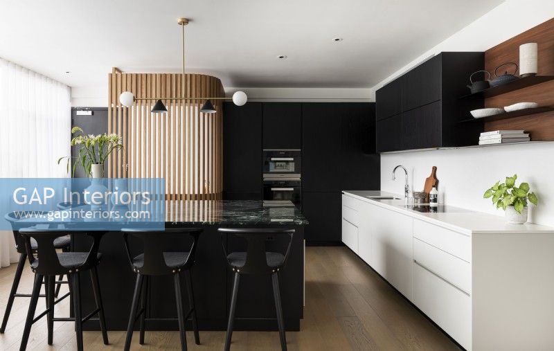 Modern black and white kitchen with island.