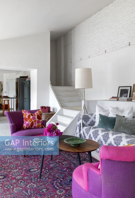 Pink and purple chairs in eclectic living room