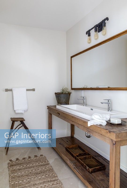 Repurposed wooden table as sink unit in country bathroom