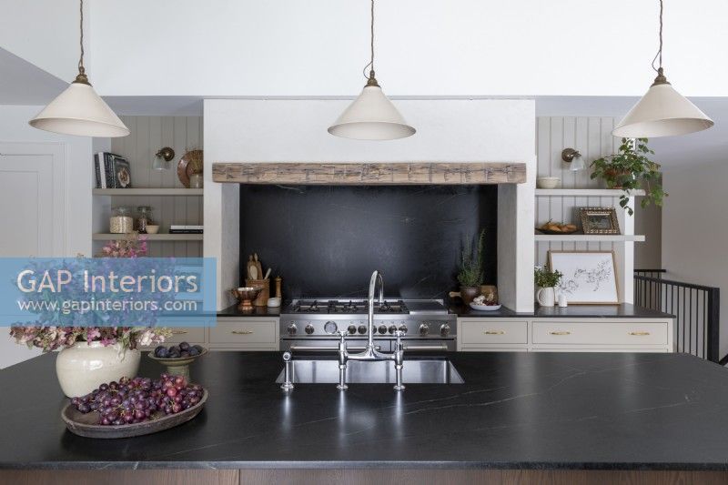 Large range cooker within fireplace in country kitchen