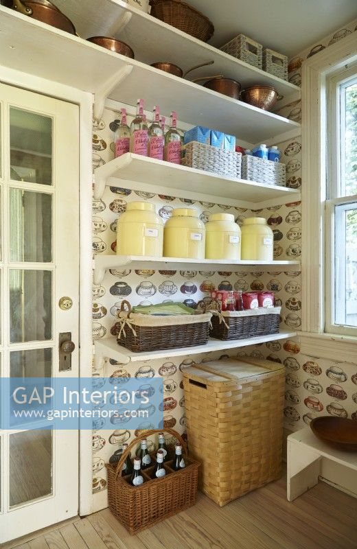 Open shelving pantry with teacup wall paper