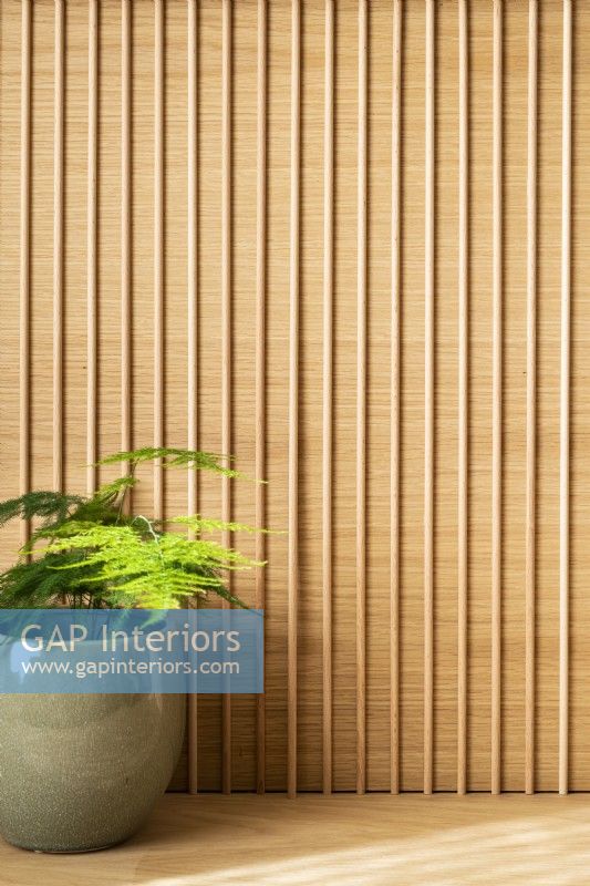 Detail in office of wooden slatted wall.