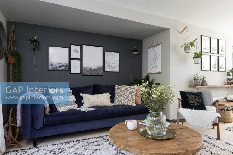 contemporary sitting room with alcove sofa in blue velvet