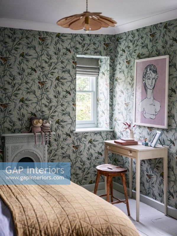 Bedroom with tropical bird wallpaper and writing desk