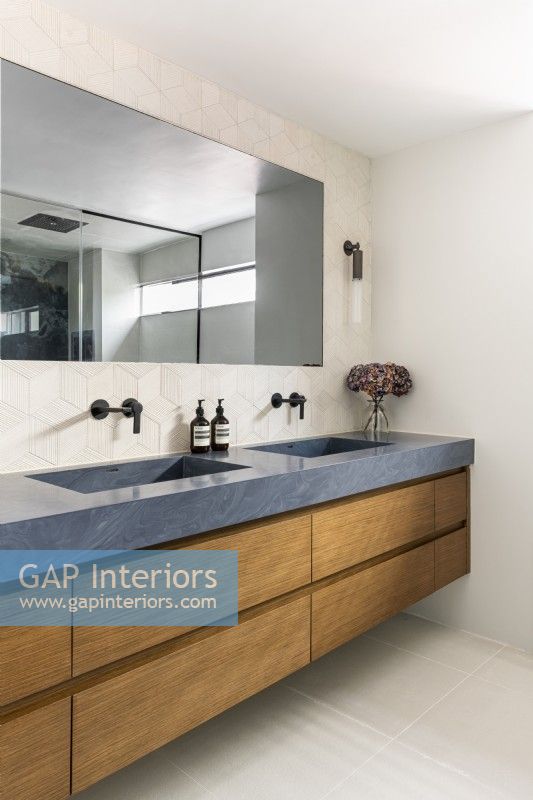 Contemporary bathroom with large wall hung double vanity unit.