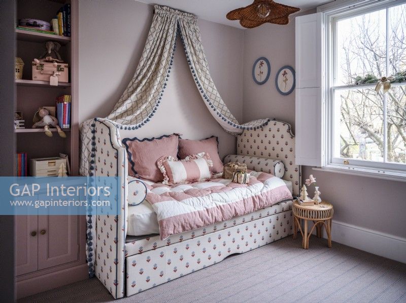 Upholstered daybed with canopy drapes