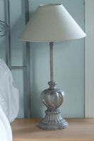 Boonshill Farm, East Sussex. Interior of bedroom with metal bedside lamp. 