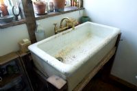 boonshill farm, east sussex. interior of pantry with old sink found in garden with reclaimed wooden stand made by mick shaw. 