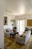 Corfu,Greece. Yialiskari House Villa near Kalami. Living room showing sofas and stone floor