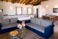 Villa Christina, Kaminaki, Corfu, Greece.  Open plan living and dining room with sofas and dining table