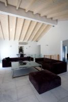 Corfu, Greece. Villa Kalokairi near Kalamaki. Living room with glass table and loungers