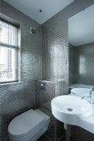 Modern contemporary bathroom with white suite and silver honeycomb effect  mosaic tiles
