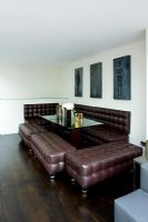 Modern dining room with brown leather benches