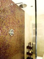 Detail of modern shower encloser with mosaic tiles