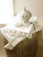 Detail of towels on ornate ethnic laundry bin