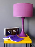 Detail of purple retro lamp on side table with retro clock