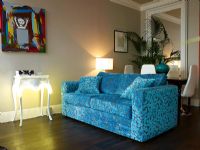 Modern living room with blue pattern fabric sofa and ambient lighting