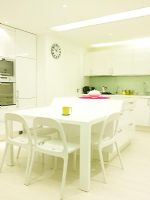 Modern white kitchen with dining table