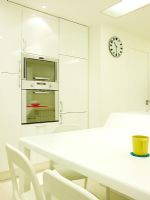 Modern white kitchen diner with built in overn