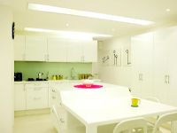Modern white kitchen with dining table