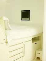 Detail of built in cabin bed with wall mounted plasma screen television 