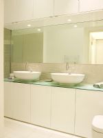 Modern white bathroom with twin basins and tiled splashback