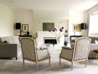 Classic living room with patterned armchairs and grey sofas