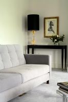 Grey sofa in classic living room with console tale in background