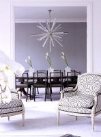 View to classic dining room with classic dining table and contemporary chandelier