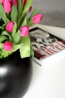 Detail of vase of tulips on coffee table