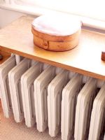 Detail of traditional radiator under shelf in bathroom
