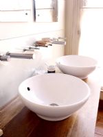 Twin basins with wall mounted taps in modern bathroom 
