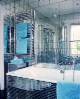 Modern bathroom with mirrored mosaic and large tiles