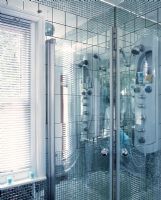 Modern shower with mirrored mosaic and large tiles