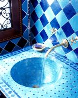 Quirky bathroom with blue tiled walls and sink